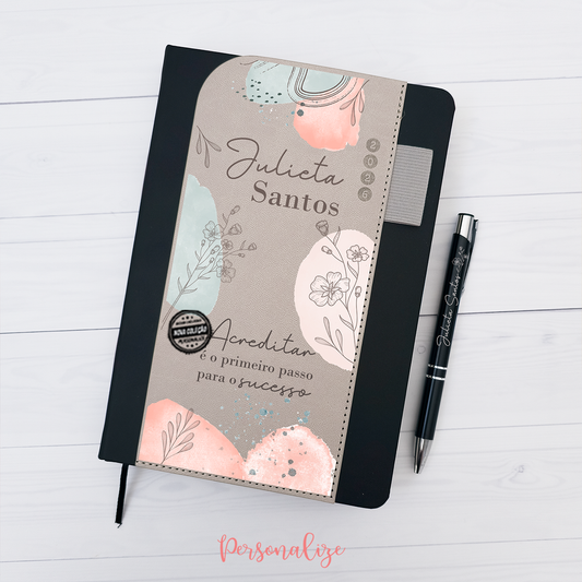 Agenda diária A5 2026 com caneta "Acreditar é o primeiro passo..."